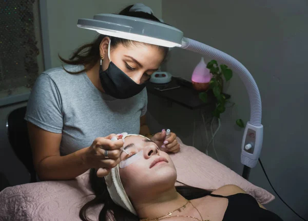 Young woman receiving natural eyelash lift treatment