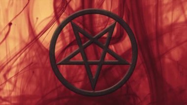 Ters çevrilmiş pentagram yakın plan. Kırmızı mürekkep hareket halinde. Soyut arkaplan