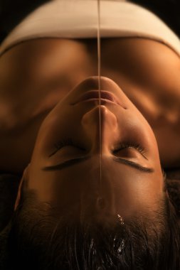 Shirodhara massage - close-up clipart