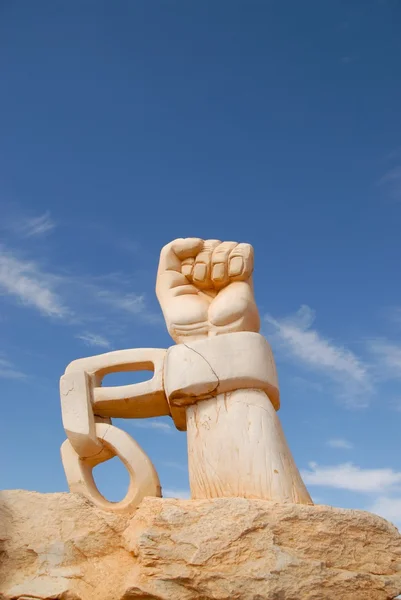 Bir kayanın masmavi gökyüzü altında zincirlenmiş taş el