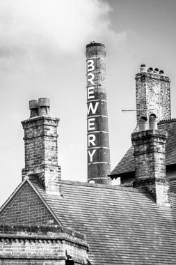 Bir bira fabrikasının bacası Bir evin çatısında yükseliyor, Portre Oryantasyonu