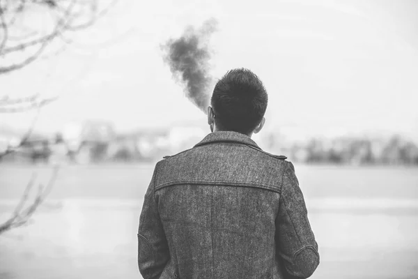 Man with beard vaping outdoor — Stock Photo, Image