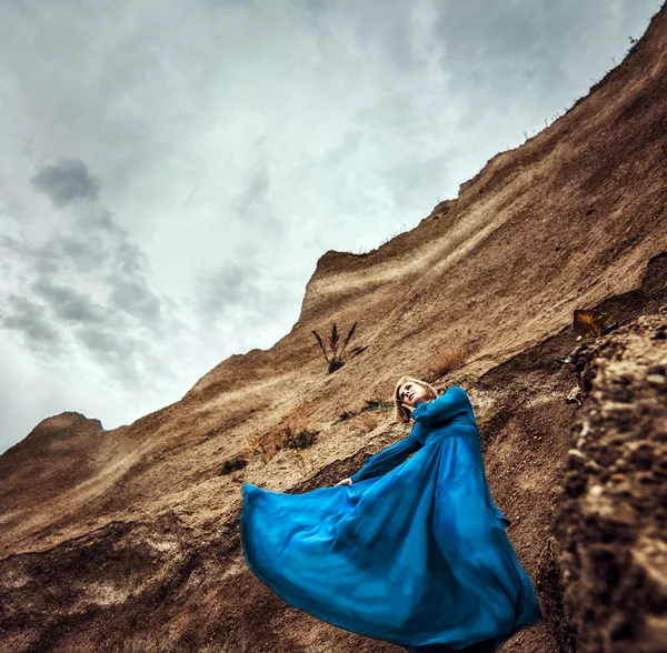 Woman in long blue dress — Stock Photo, Image