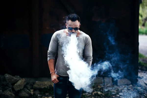 Man in sunglasses vaping outdoor — Stock Photo, Image