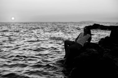 Kız günbatımı zamanda deniz kenarında