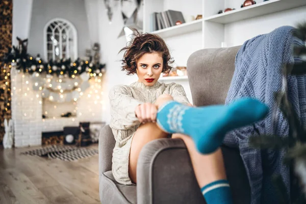 Pretty Happy Brunette Sitting Warm Sweater Chair Christmas Lights — Stock Photo, Image