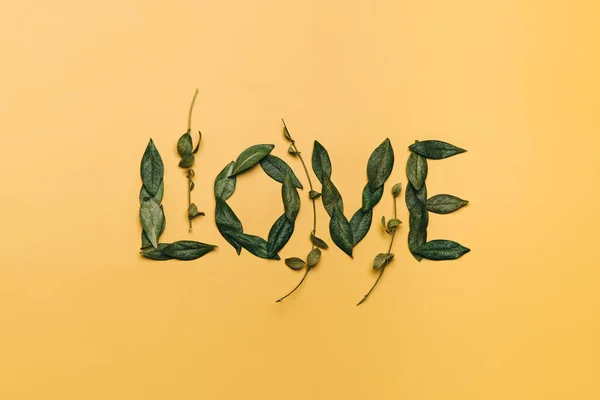 Creative Flat Lay Word Love Made Natural Leaves Yellow Background — Stock Photo, Image