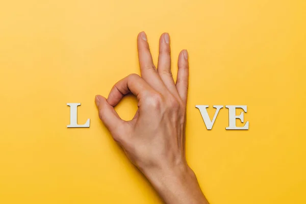 Flat Lay Woman Hand Part Word Love Yellow Background — Stock Photo, Image