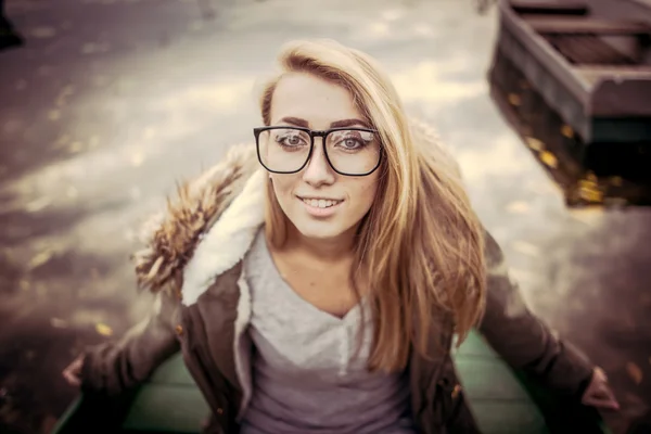 Young woman on a boat outdoors, autumn time — Stock Photo, Image