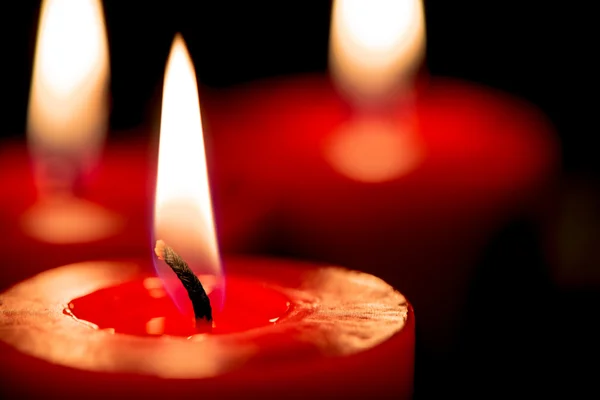 Closeup of burning candles on black background, christmas, holid — Stock Photo, Image