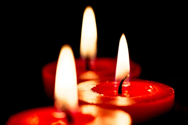 Closeup of burning candles on black background, christmas, holid — Stock Photo, Image