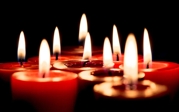 Burning candle on the black background — Stock Photo, Image