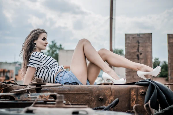 Girl on thr truck in blue shorts — Stock Photo, Image