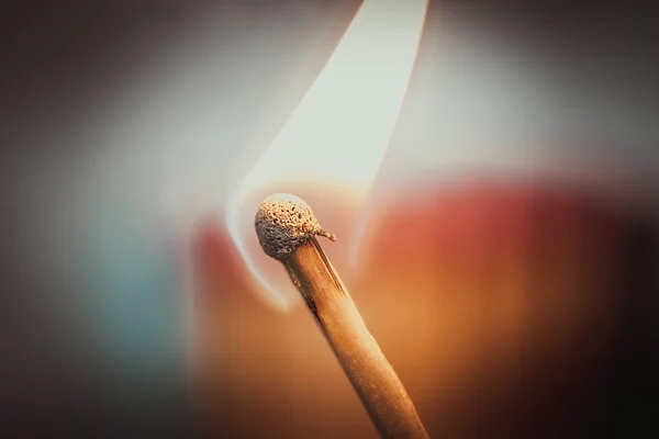 Single burning match on warm background — Stock Photo, Image