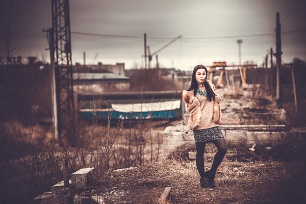 Long hair brunette girl outdoor with old industrial view behind, — Stock Photo, Image