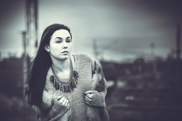 Long hair brunette girl outdoor with old industrial bridge behin — Stock Photo, Image