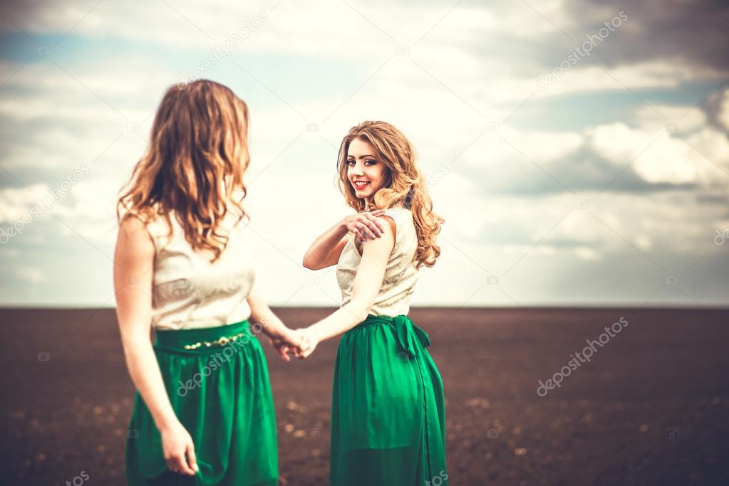 Pretty girls outdoor walking in the field,