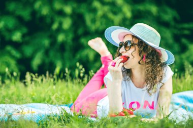 Pretty girl outdoor lying on the grass