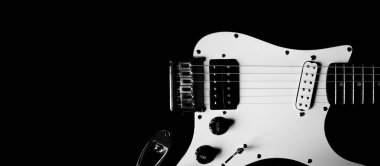 Siyah arka planda elektro gitarın bir parçası, kopyalama alanı. Siyah beyaz gitar yakın çekim. Yaratıcı fotoğrafçılık, kırpma. Konsept müzik web günlüğü, afiş, poster, kapak
