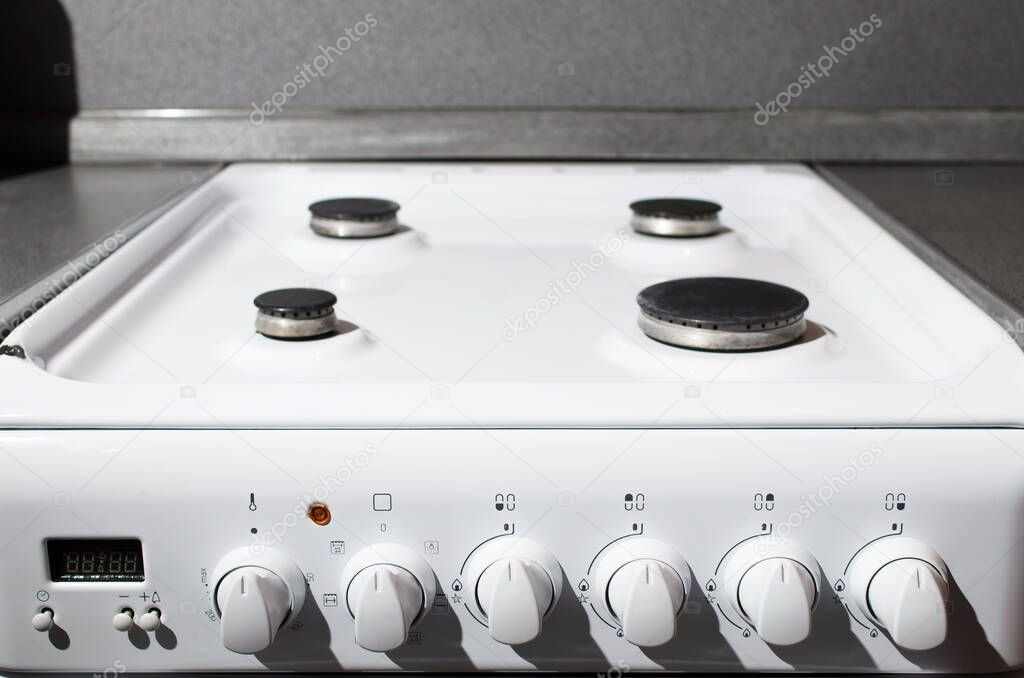 Clean white surface of gas stove. Gas panel after cleaning
