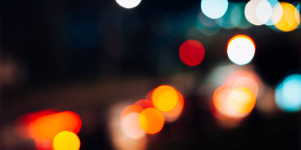 Night city lights defocus, blurred abstract background, lanterns and cars traffic, bokeh effect