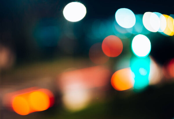 Blurred abstract background night city lights defocus, lanterns and cars traffic, bokeh effect, soft focus
