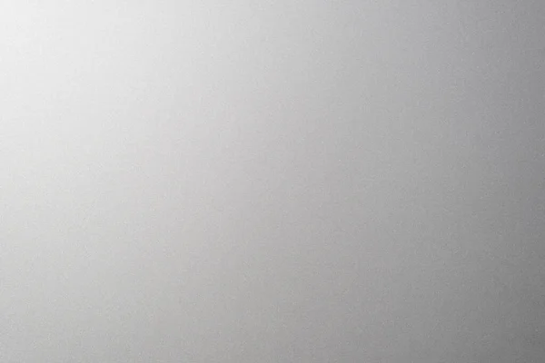 Matte gray smooth plastic surface with fine texture and vignette on the right side. Exquisite textured background, soft blank backdrop.