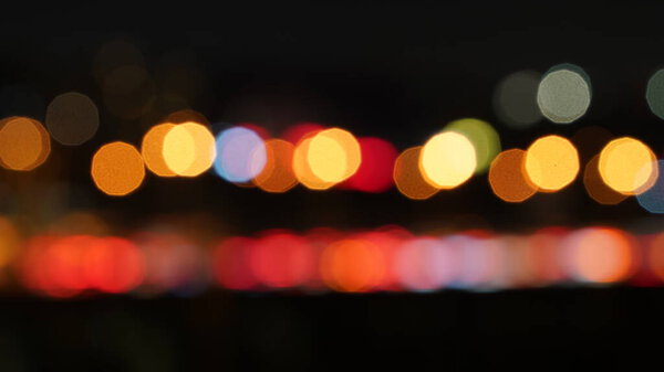 The blurred city night view with the colorful lights on at night