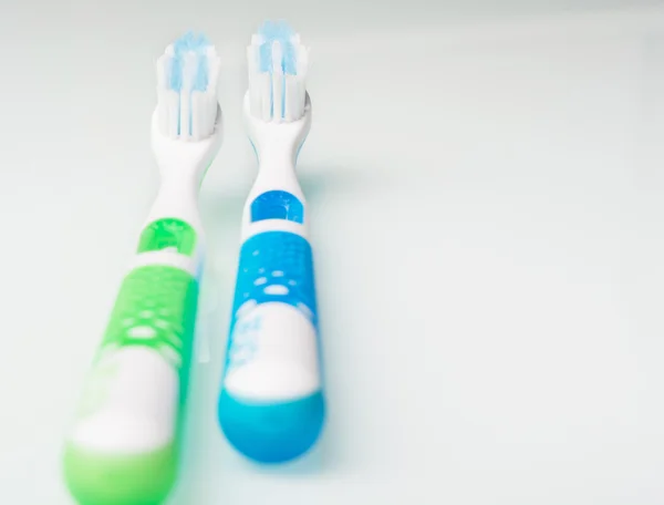 Toothbrushes on the glass table — Stock Photo, Image