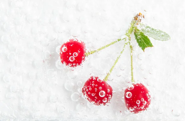 Cerejas suculentas em bolhas de água — Fotografia de Stock