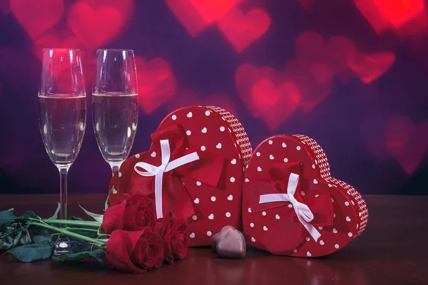 Valentinstag Zusammensetzung Zwei Rote Geschenkboxen Mit Schleifen Zwei Sektgläser Schokoladenbonbons — Stockfoto