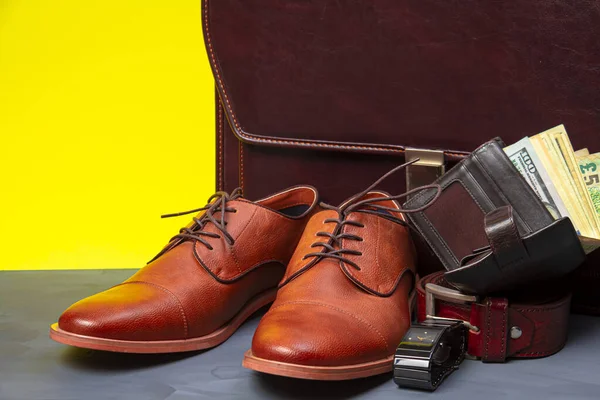 Collection of men's accessories. Men's shoes, belt, watch, wallet with money and briefcase. Mens accessories background.