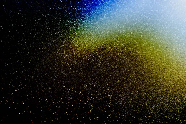 Particles of light and dust on a dark blue background. Abstract background. Space.