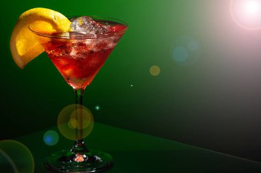 Yeşil arka planda buzlu ve limonlu bir bardak martini. Yemek fotoğrafı..