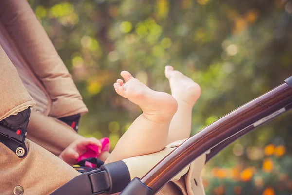 Child is lie in a carriage. — Stock Photo, Image