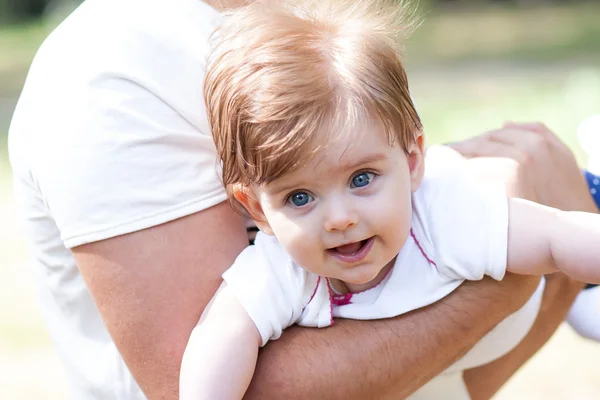 Father holds on hands of his daughter. — Stock Photo, Image