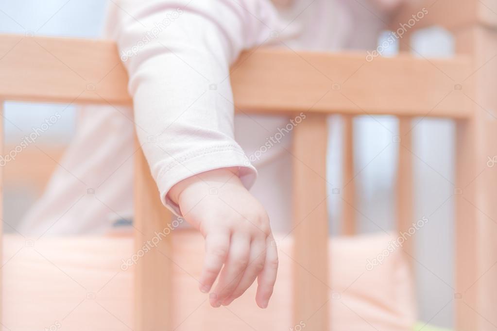 small child standing in a crib