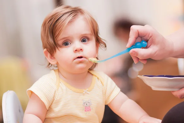 Little girl feeding from a spoon — Stock Photo, Image