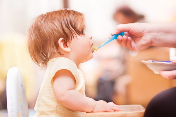 Little girl feeding from a spoon — Stock Photo, Image