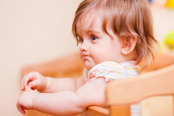 Little girl standing in the crib — Stock Photo, Image