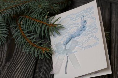 Köknar dalları arasında tebrik kartı. Siyah çam tahtalarında.