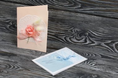 Mavi ve pembe tonları olan tebrik kartları. Simsiyah tahtalar üzerinde,.