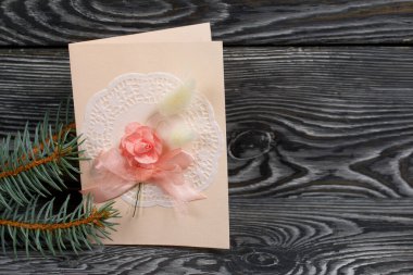 Pembe gözlüklü tebrik kartı. Spruce şubesi. Simsiyah tahtalar üzerinde,.