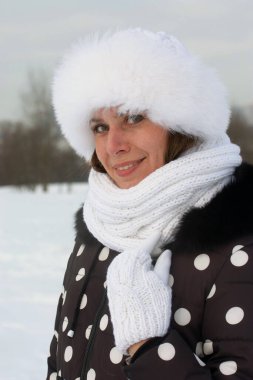 Kışın yürüyüşe çıkan genç bir kadın. Kış kıyafetleri içinde. Etrafta çok kar var..