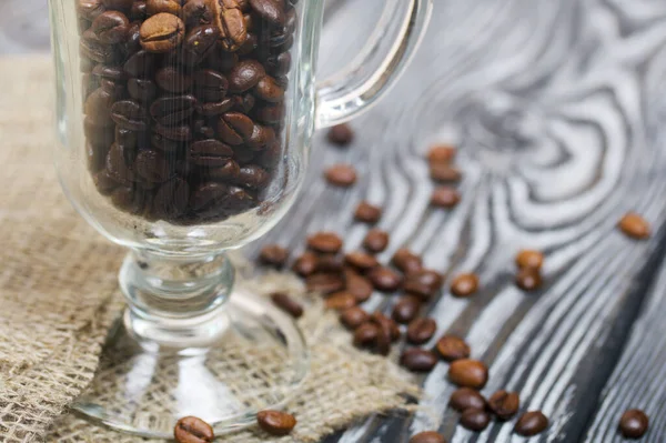 Coffee Beans Poured Glass Beaker Stands Linen Pine Boards Close — Stock Photo, Image