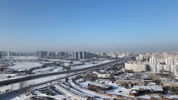 Dálnice projíždí metropolí. Zimní krajina. Letecké video natáčení městských krajin. — Stock video