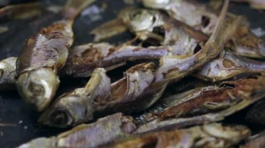 Nehir balığı fırında pişti ve kurudu. Fırın tepsisinde yatıyor. Yakın çekim.