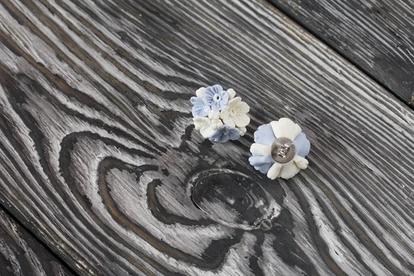 Handmade jewelry. Earrings made of polymer clay. Lies on pine boards.