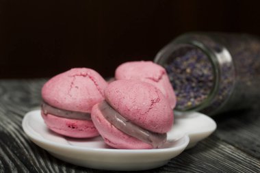 Beyaz çikolata ve yaban mersinli lavantalı makarna pastası. Yakınlarda lavanta çiçekleri var.