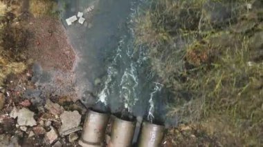 Flying over concrete sewers. Streams of water flow through concrete pipes. Polluted body of water in the park.